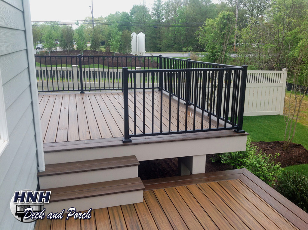 Trex Transcend composite deck with Westbury black aluminum railing and balusters.