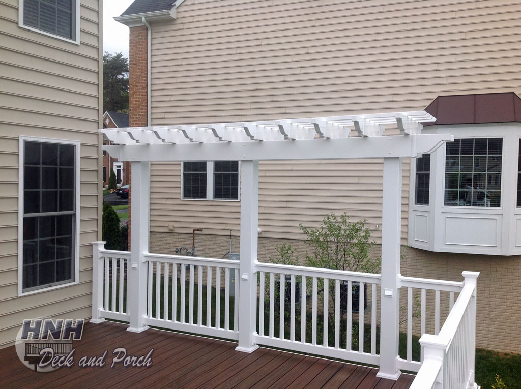 Deck with a white vinyl pergola and led accent lights from i-lighting.