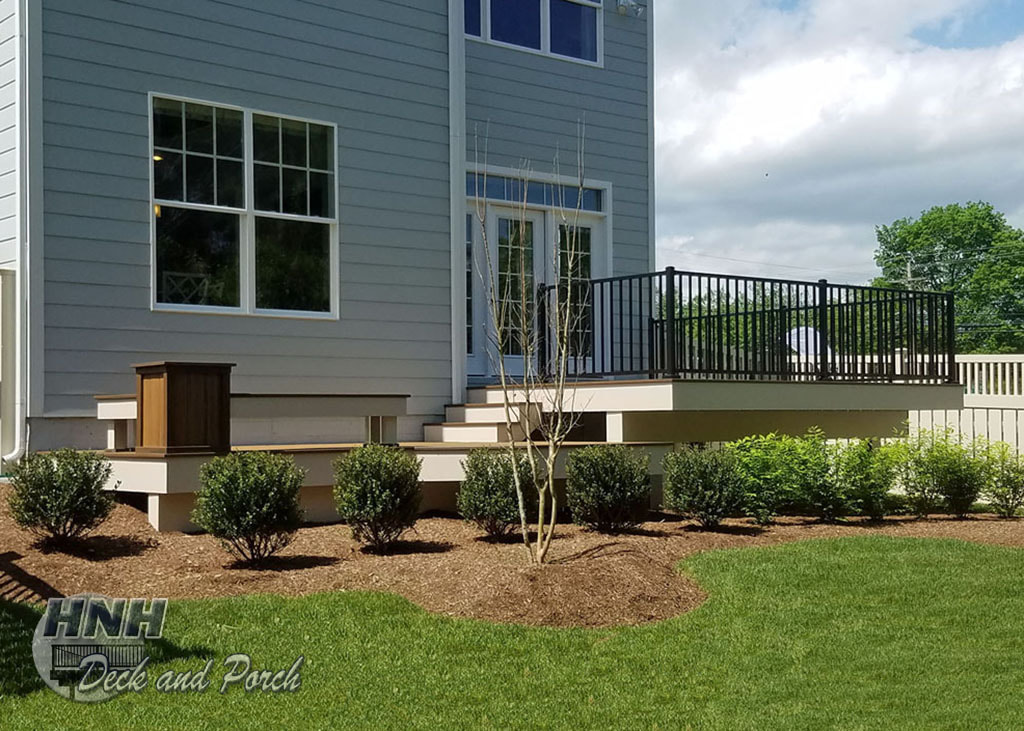 Trex Transcends composite deck, Havana Gold and Spiced Rum flooring, Westbury black aluminum railing and square balusters