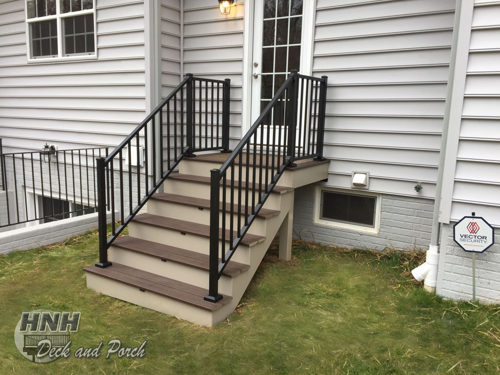 Trex Transcend steps, Spiced Rum landing and Vintage Lantern steps with ilighting accent lights and Westbury black aluminum railing.