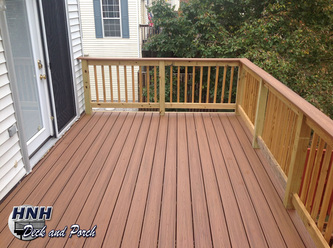 Composite deck using Trex Transcend Tiki Torch flooring and cap rail with pressure treated wood railing.