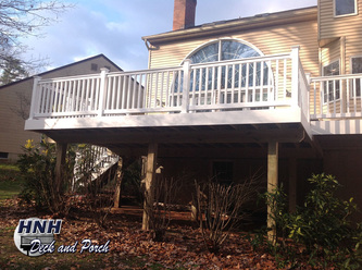 Low maintenance deck with white vinyl railing and balusters.