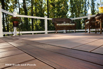 Vinyl deck using Wolf PVC Decking Tropical Hardwoods Collection with Amberwood flooring and Rosewood border.