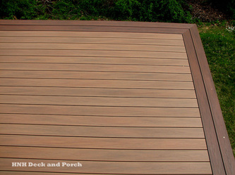 Vinyl deck using Wolf PVC Decking Tropical Hardwoods Collection with Amberwood flooring and Rosewood border.