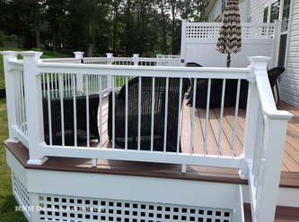 Vinyl deck using white Wolf Home Products vinyl railing with white aluminum balusters.