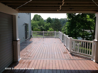 Vinyl deck using Wolf Tropical Hardwoods Collection PVC Decking with Amberwood flooring and Rosewood border.